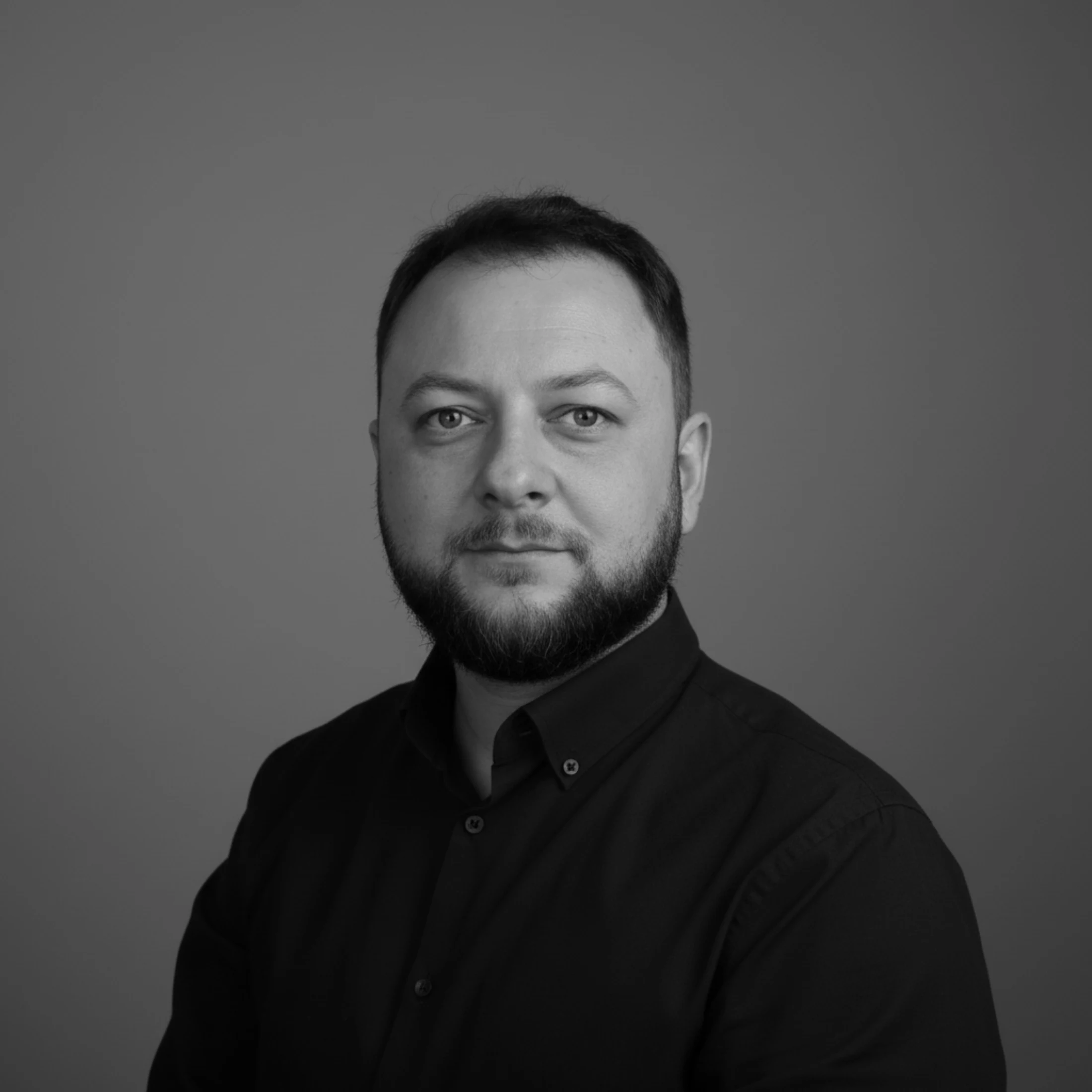 Black and white portrait of Adrian Matousu, founder of Escave Group