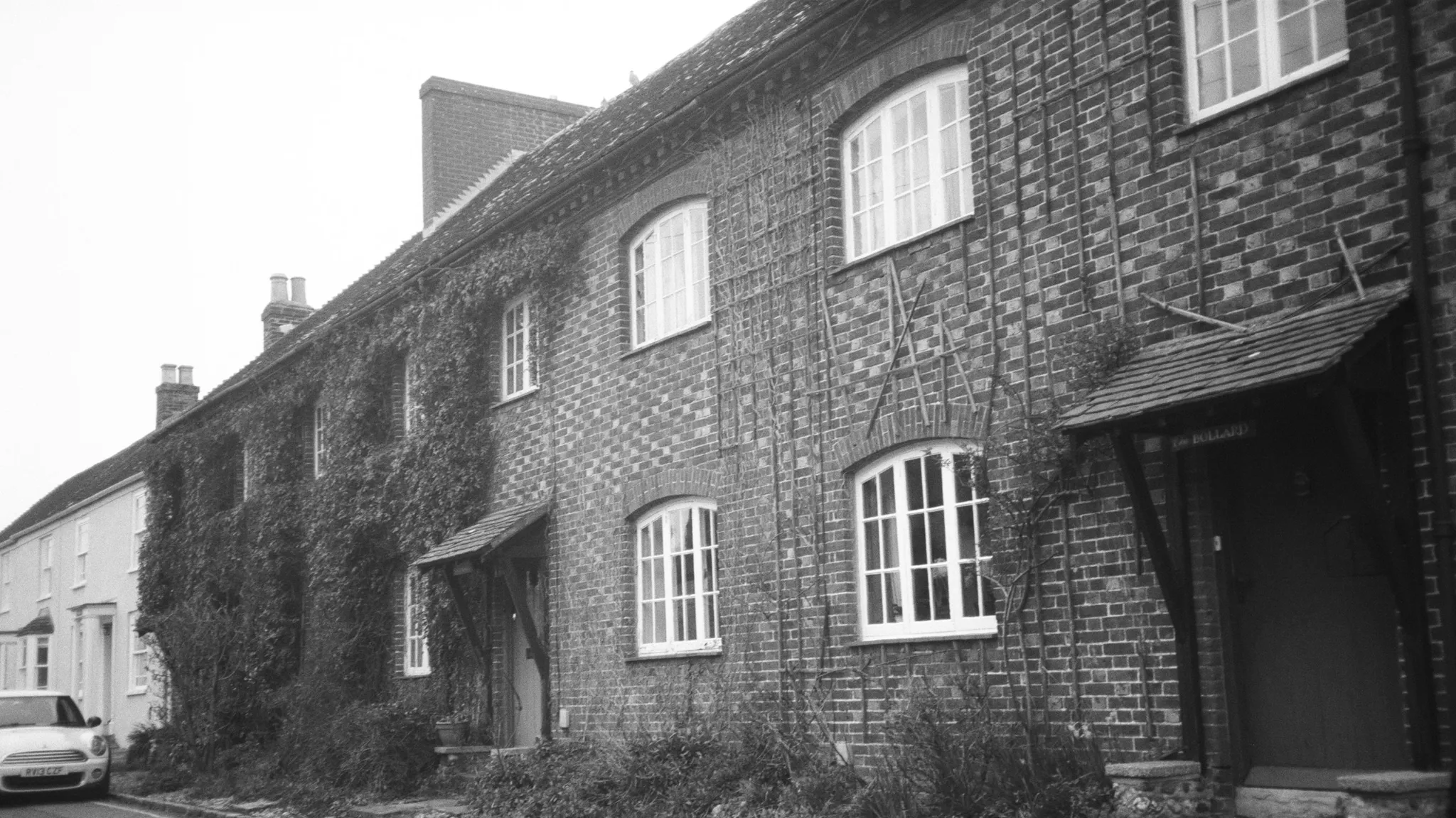 Row of traditional British brick terraced houses in black and white